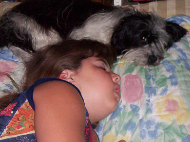 Gabrielle sleeping with Havanese named Freedom